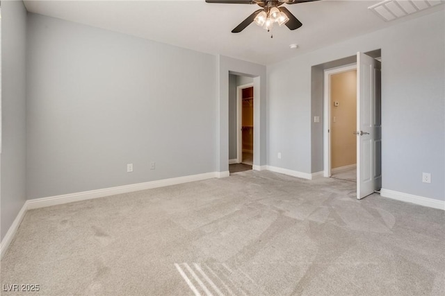 empty room featuring light colored carpet and ceiling fan