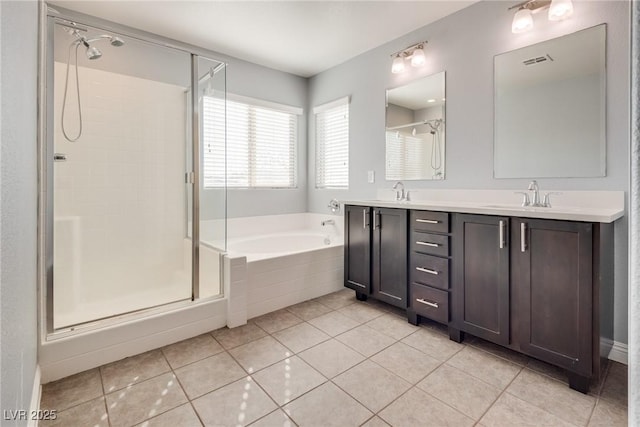 bathroom with tile patterned flooring, vanity, and separate shower and tub