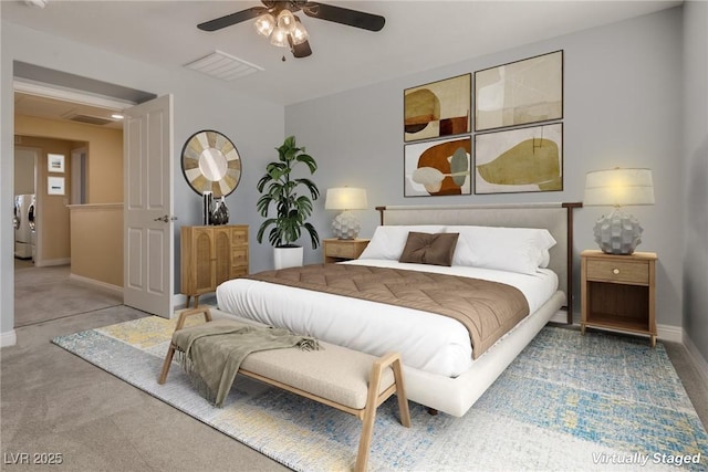 carpeted bedroom with separate washer and dryer and ceiling fan