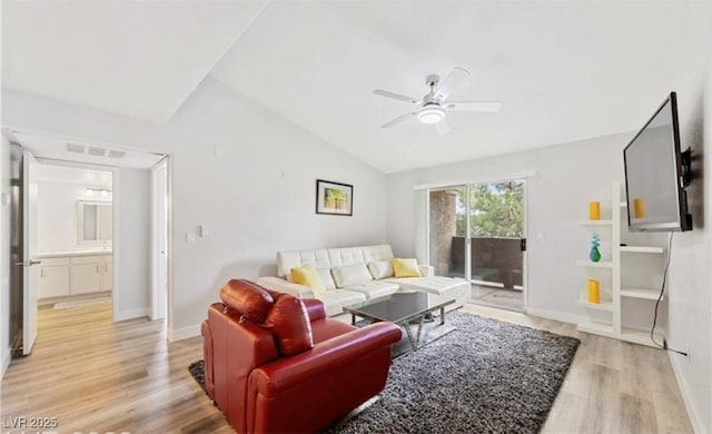 living room with vaulted ceiling, ceiling fan, and light wood-type flooring