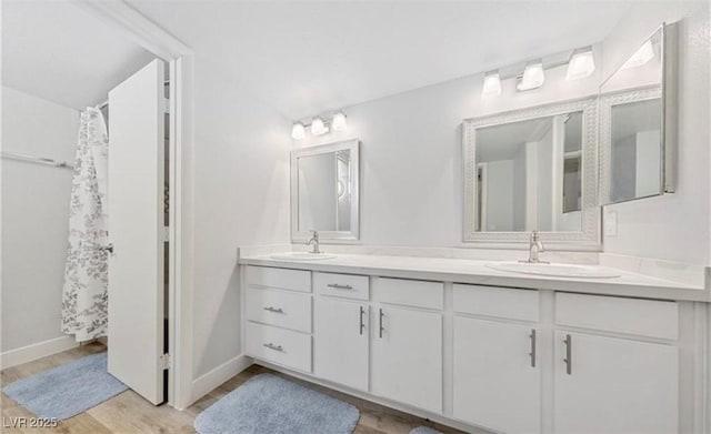 bathroom featuring walk in shower, wood-type flooring, and vanity