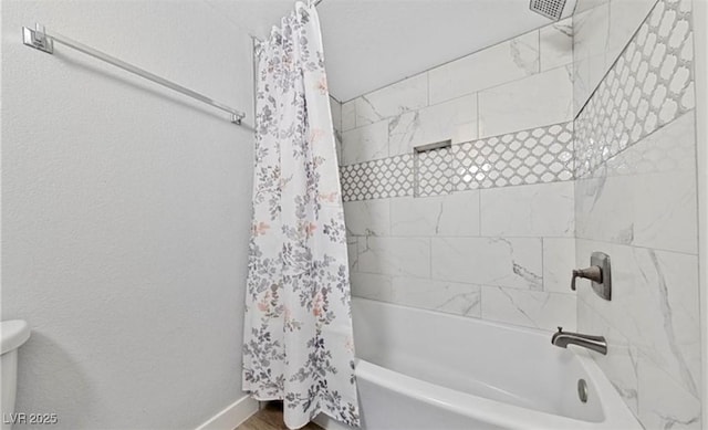 bathroom with shower / bath combo with shower curtain