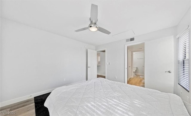 bedroom featuring ensuite bath, light hardwood / wood-style floors, and ceiling fan