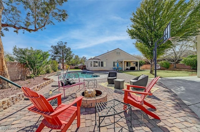 view of swimming pool featuring a patio and a fire pit