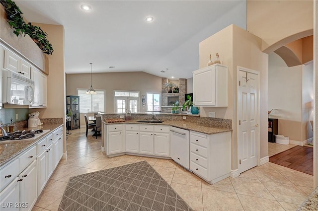 kitchen featuring light tile patterned flooring, pendant lighting, white cabinetry, kitchen peninsula, and white appliances