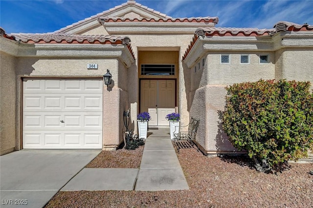 doorway to property with a garage