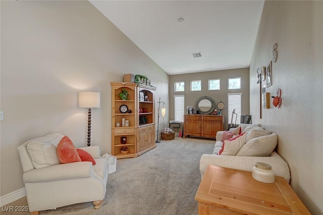 living area featuring carpet and high vaulted ceiling