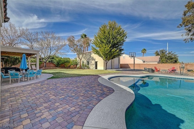 view of swimming pool featuring a storage shed, a lawn, and a patio