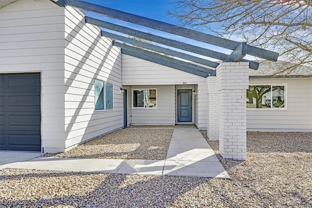 doorway to property with a garage