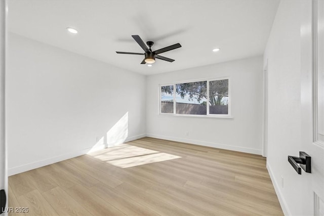 spare room featuring ceiling fan and light wood-type flooring