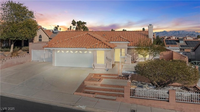 view of front of house featuring a garage and a mountain view