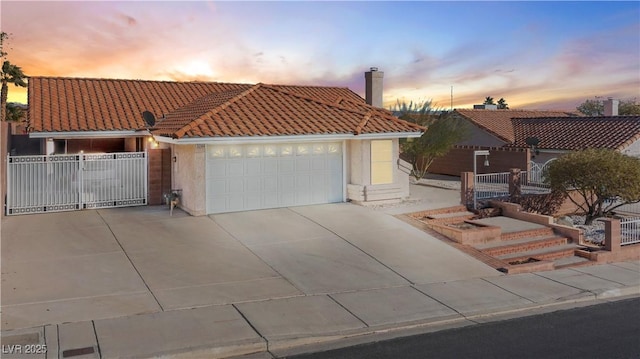 mediterranean / spanish-style house with a garage