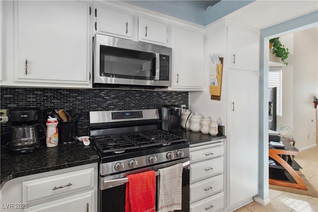 kitchen with light tile patterned floors, decorative backsplash, stainless steel appliances, and white cabinets