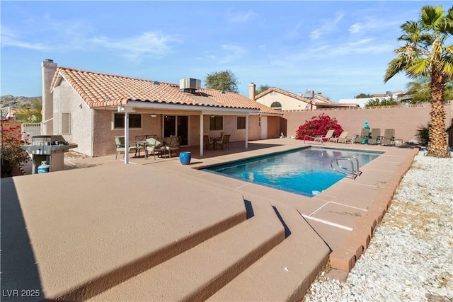 view of swimming pool featuring a patio and central air condition unit