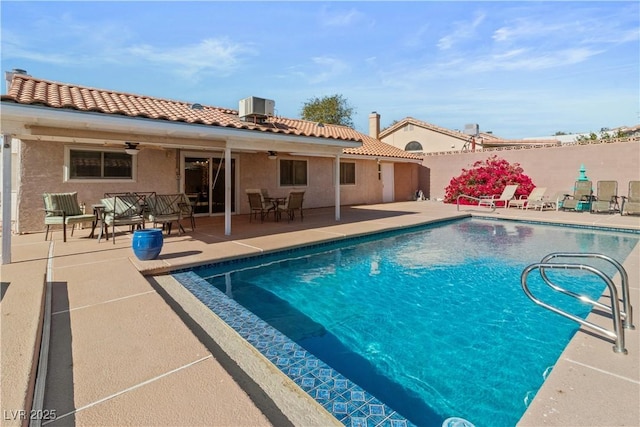 view of pool with central AC, ceiling fan, and a patio area