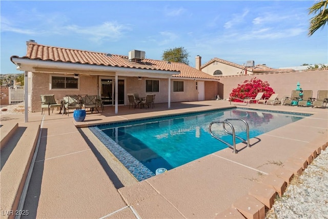 view of pool with central AC, a patio, and ceiling fan