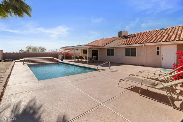 view of pool with a patio and central air condition unit