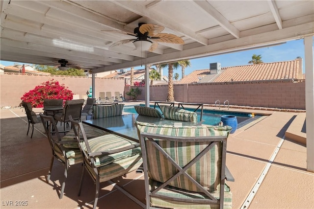 view of patio / terrace with a fenced in pool and ceiling fan