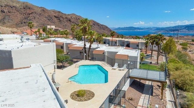 view of swimming pool featuring a mountain view and a patio