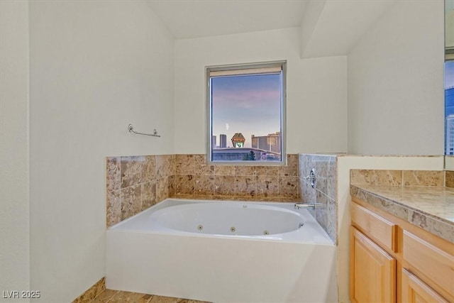 bathroom with a jetted tub and vanity