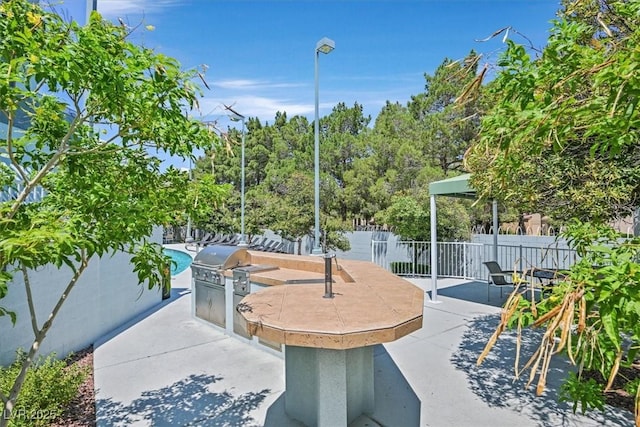 view of patio featuring area for grilling, grilling area, and a fenced backyard