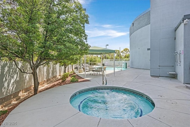 view of pool with a fenced backyard, a patio, and a hot tub