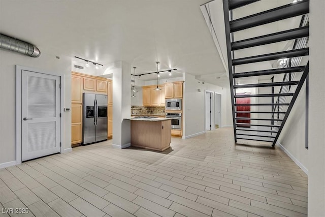 kitchen with light brown cabinets, visible vents, light countertops, appliances with stainless steel finishes, and decorative backsplash