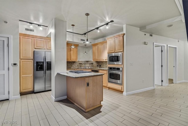 kitchen with light brown cabinets, stainless steel appliances, a kitchen island, hanging light fixtures, and light stone countertops