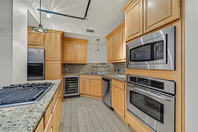 kitchen featuring wine cooler, tasteful backsplash, visible vents, hanging light fixtures, and appliances with stainless steel finishes