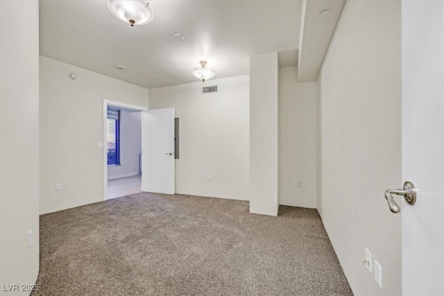 empty room with carpet flooring and visible vents