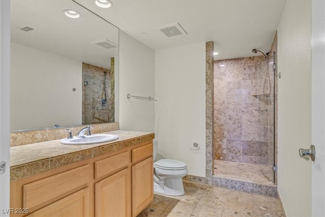 full bath with visible vents, a stall shower, vanity, and toilet