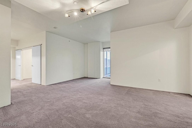 empty room featuring light carpet