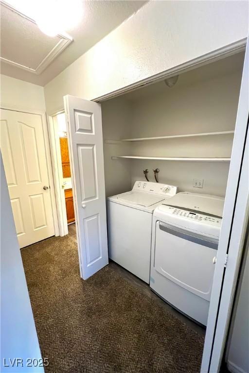 washroom featuring washing machine and clothes dryer and dark colored carpet