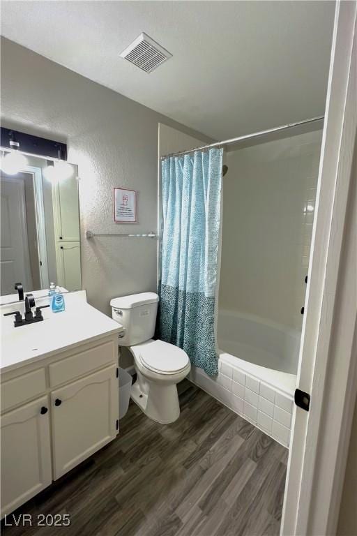 full bathroom with shower / tub combo with curtain, wood-type flooring, toilet, and vanity