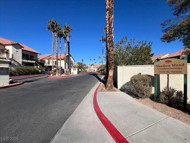 view of street featuring sidewalks, a residential view, and curbs