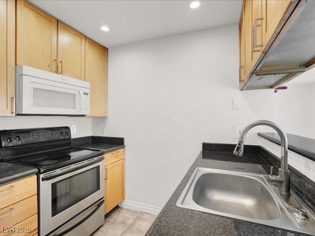 kitchen featuring light brown cabinetry, electric stove, a sink, dark countertops, and white microwave
