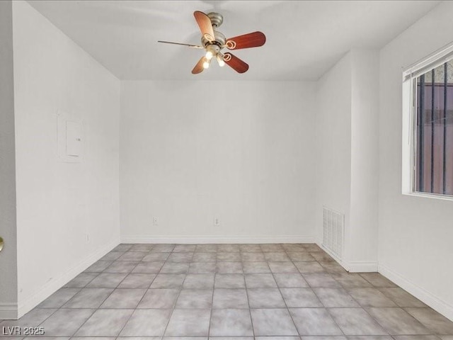 spare room with visible vents, baseboards, and ceiling fan
