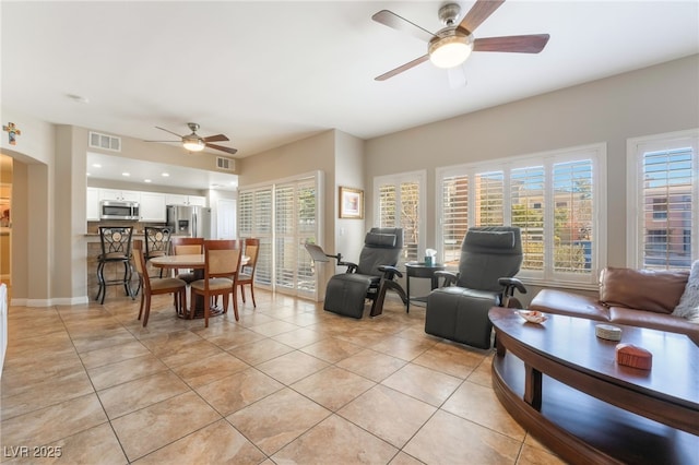 living room featuring ceiling fan and light tile patterned flooring