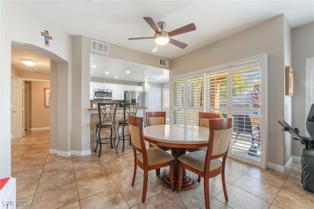 tiled dining room with ceiling fan