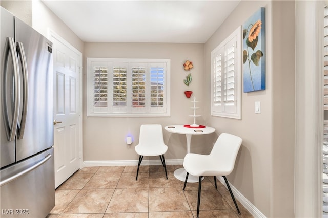 tiled dining space featuring a healthy amount of sunlight