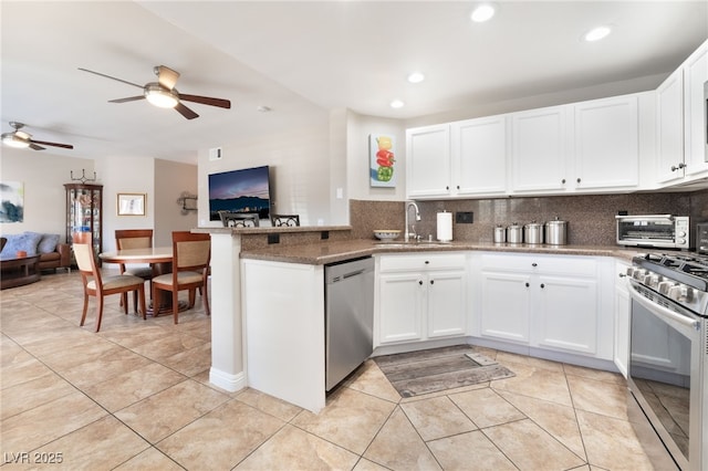 kitchen featuring white cabinetry, stainless steel appliances, and kitchen peninsula