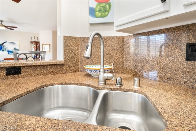 details featuring tasteful backsplash, ceiling fan, sink, and stone counters