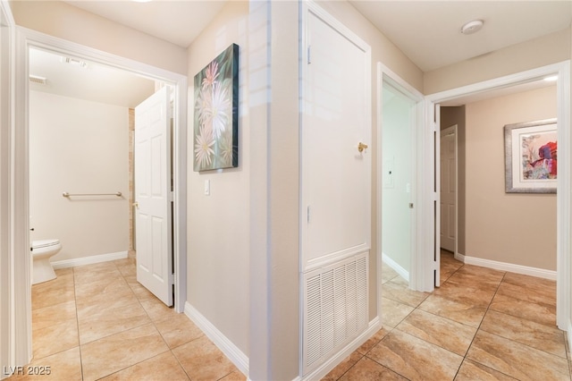 hallway featuring light tile patterned floors