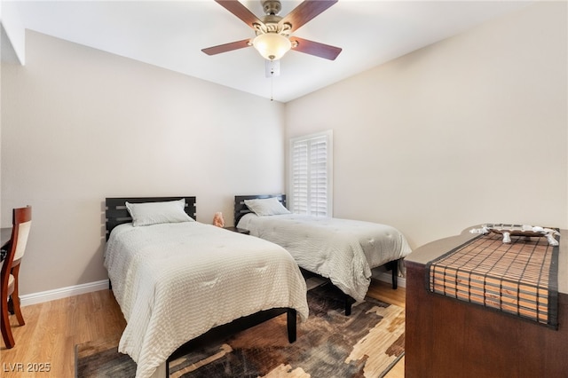 bedroom with wood-type flooring and ceiling fan