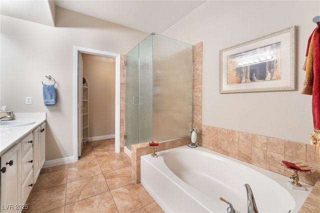 bathroom featuring independent shower and bath, vanity, and tile patterned flooring