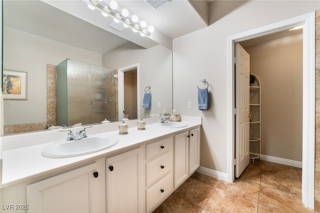 bathroom featuring tile patterned flooring, vanity, and a shower with shower door