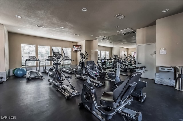 exercise room with a textured ceiling