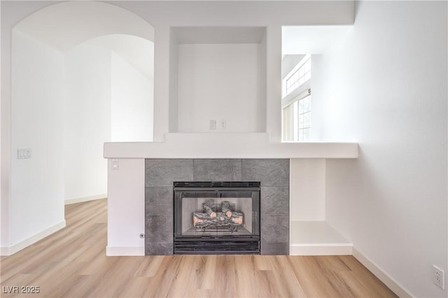 interior details with hardwood / wood-style flooring and a fireplace