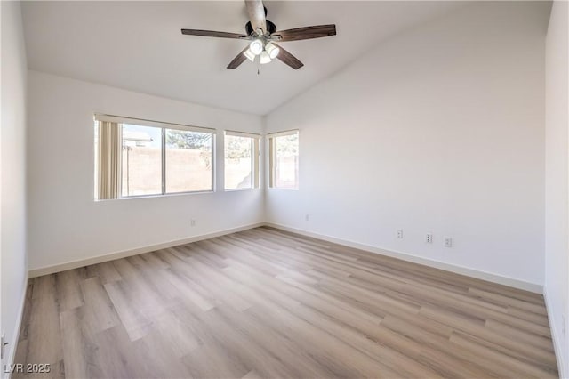 empty room with ceiling fan, lofted ceiling, and light hardwood / wood-style floors