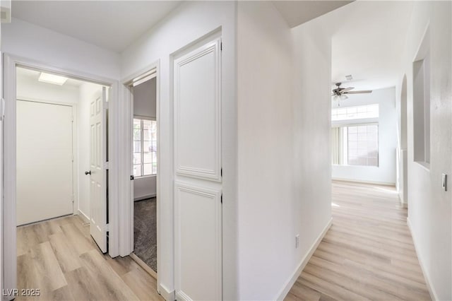 hallway with light hardwood / wood-style floors